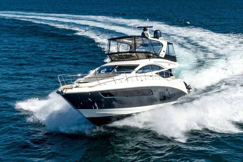 Slide: The Image of 2018 Sea Ray L590 Fly yacht cruising on open water. - 5