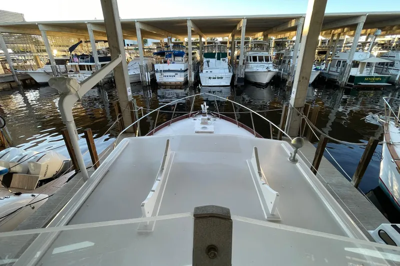 Slide: The Image of 1958 Huckins Seafarer yacht docked in a marina with multiple boats. - 10