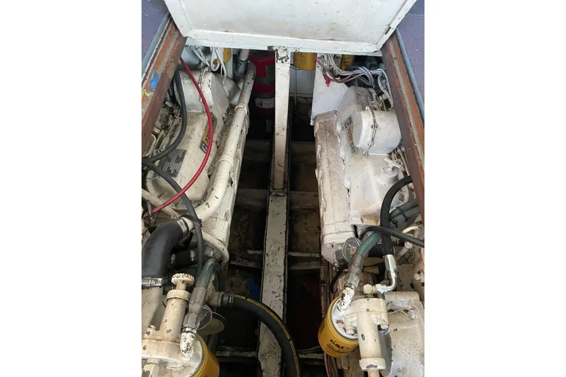 Slide: The Image of Engine compartment of a 1958 Huckins Seafarer boat, showcasing dual engines and mechanical components. - 19