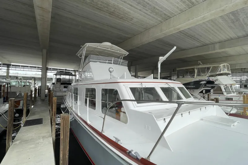 Slide: The Image of 1958 Huckins Seafarer yacht docked in a covered marina, showcasing classic design. - 3