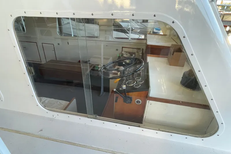 Slide: The Image of 1958 Huckins Seafarer boat interior with steering wheel and control panel. - 5