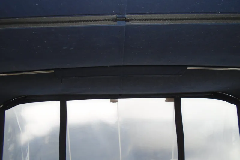 Slide: The Image of 1989 Sea Ray 300 Weekender boat interior with blue canopy and clear windows. - 11