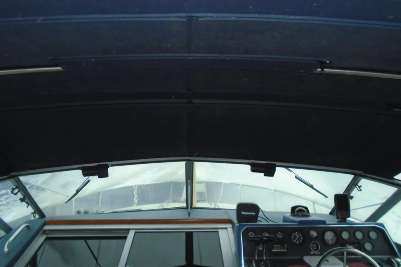 Slide: The Image of 1989 Sea Ray 300 Weekender boat cockpit with navigation instruments and windshield view. - 12