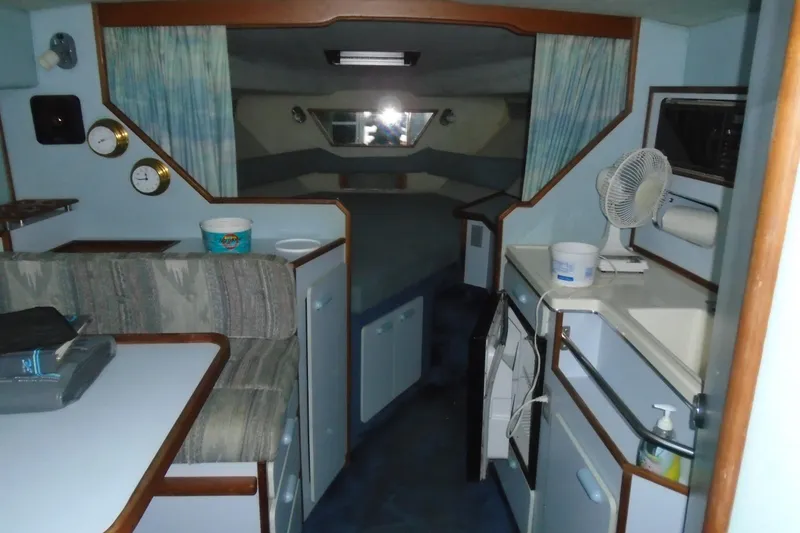 Slide: The Image of Interior of a 1989 Sea Ray 300 Weekender boat, featuring a cozy cabin layout. - 14