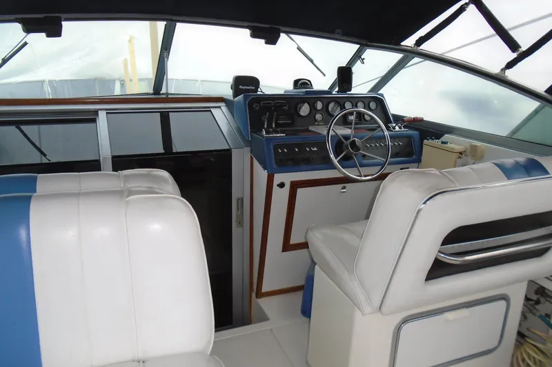 Slide: The Image of Interior of 1989 Sea Ray 300 Weekender boat with steering wheel and dashboard controls. - 2