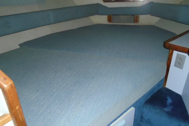 Slide: The Image of Interior cabin of 1989 Sea Ray 300 Weekender with blue upholstery and wooden accents. - 20