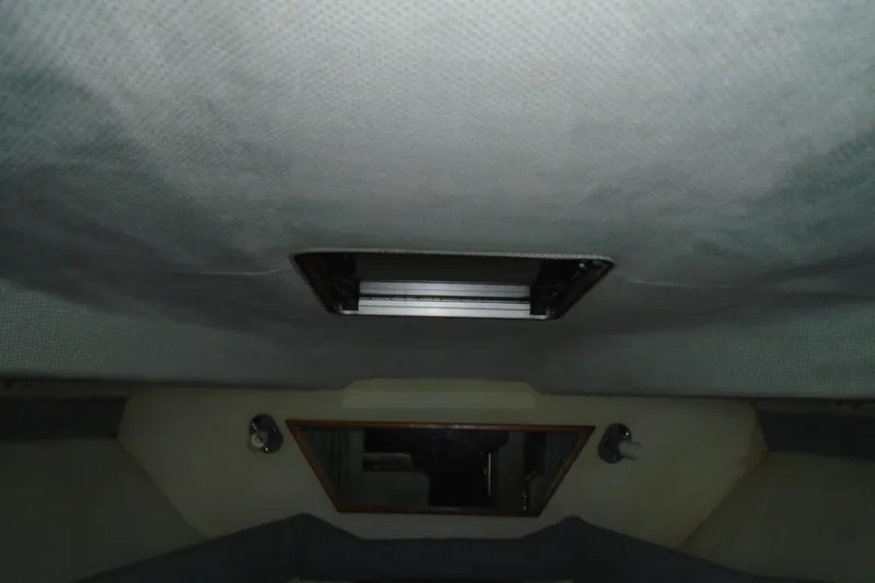 Slide: The Image of Interior cabin view of 1989 Sea Ray 300 Weekender boat, featuring ceiling vent and lighting. - 21