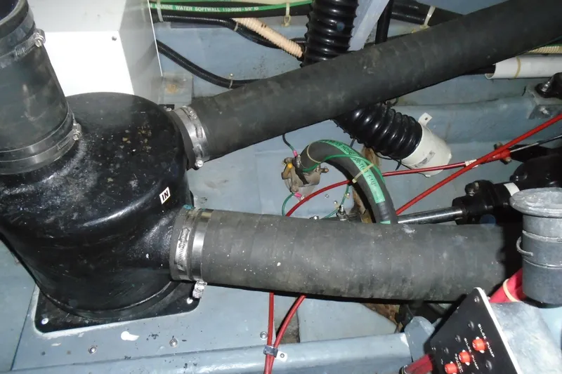 Slide: The Image of Engine compartment of a 1989 Sea Ray 300 Weekender boat, showing hoses and components. - 25