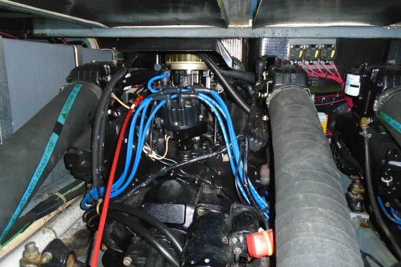 Slide: The Image of Engine compartment of a 1989 Sea Ray 300 Weekender boat, featuring wiring and hoses. - 29