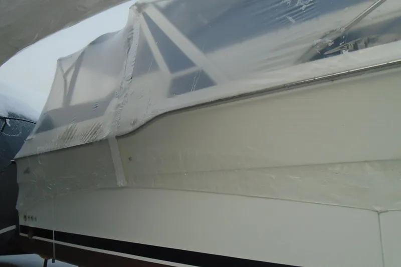 Slide: The Image of 1989 Sea Ray 300 Weekender boat covered in protective wrap. - 5