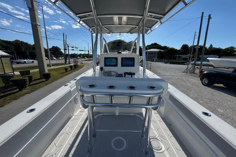 Slide: The Image of 2021 Contender 28 Tournament boat interior with helm and seating, parked outdoors. - 10