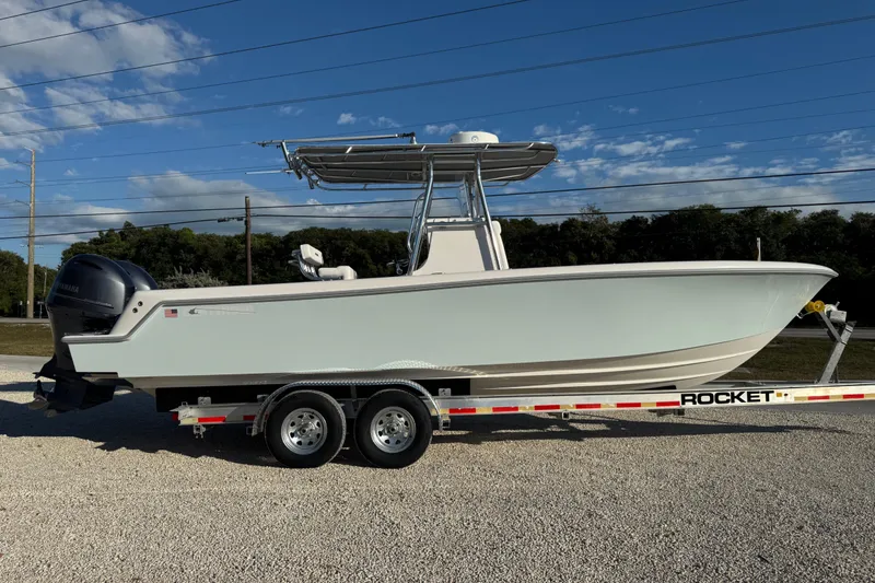 Slide: The Image of 2021 Contender 28 Tournament boat on trailer under clear blue sky. - 3