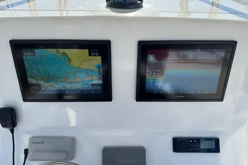 Slide: The Image of Dashboard of a 2021 Contender 28 Tournament boat with Garmin navigation displays. - 4