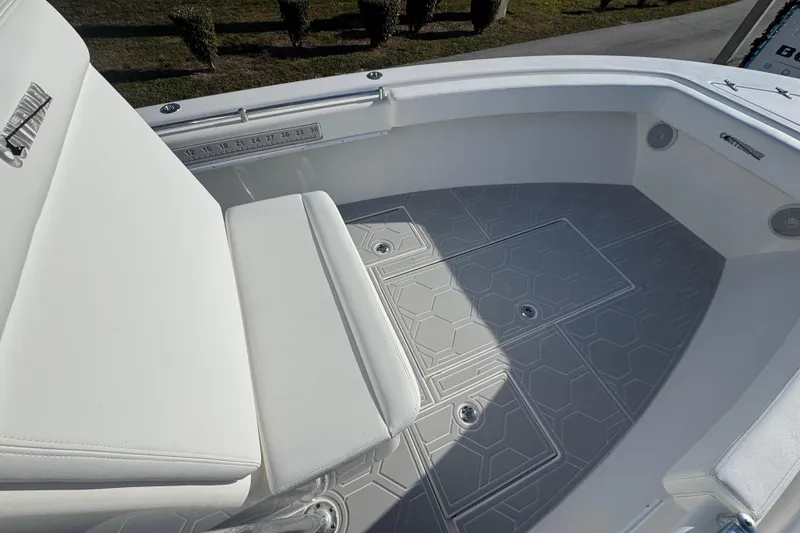 Slide: The Image of 2021 Contender 28 Tournament boat interior with cushioned seating and textured flooring. - 8