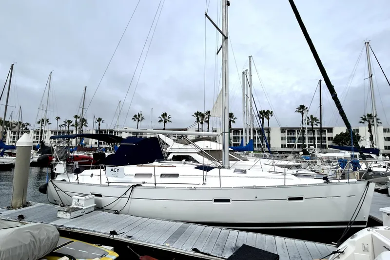 The Image of 2005 Beneteau Oceanis 373 sailboat docked at marina with palm trees in background. - 0