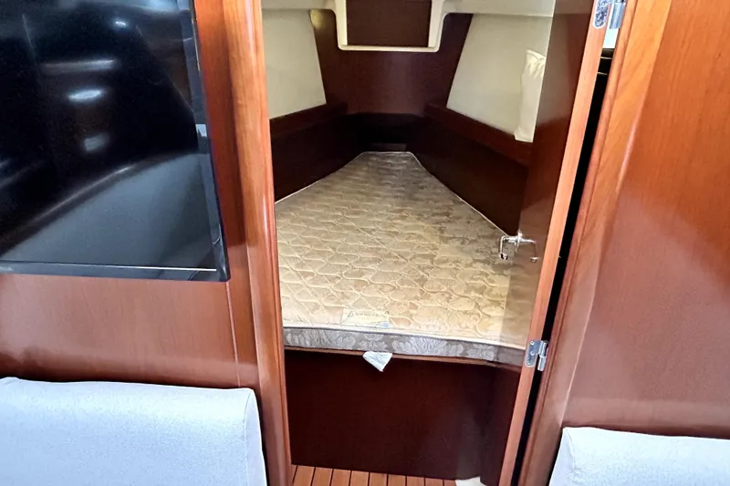 Slide: The Image of Interior cabin of 2005 Beneteau Oceanis 373 sailboat with mattress and wooden finish. - 10