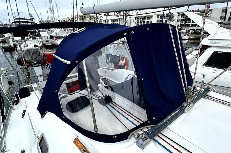 Slide: The Image of 2005 Beneteau Oceanis 373 sailboat with blue canopy in marina setting. - 14