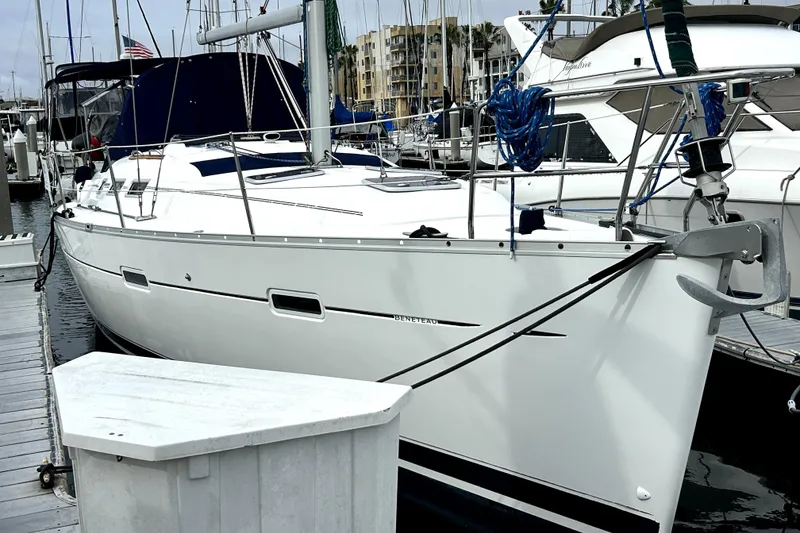Slide: The Image of 2005 Beneteau Oceanis 373 sailboat docked at marina, featuring sleek white hull design. - 2