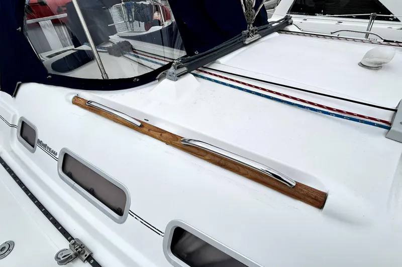 Slide: The Image of 2005 Beneteau Oceanis 373 sailboat deck with wood and metal handrail. - 21