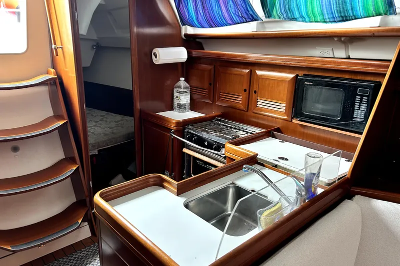 Slide: The Image of Interior of 2005 Beneteau Oceanis 373 sailboat with kitchen and cozy cabin. - 4