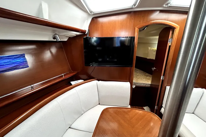 Slide: The Image of Interior of 2005 Beneteau Oceanis 373 yacht with cozy seating and mounted TV. - 6