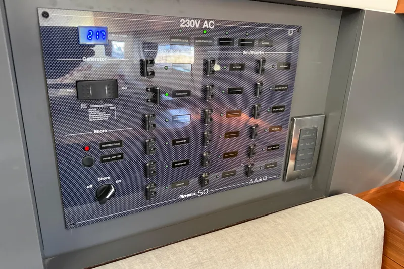 Slide: The Image of Electrical control panel on a 2020 Amel 50 yacht, displaying 230V AC system. - 14