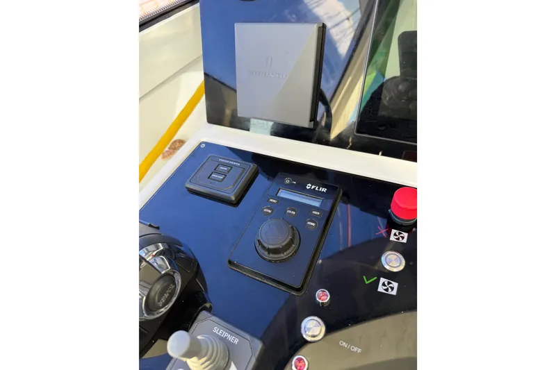 Slide: The Image of Control panel of a 2020 Amel 50 yacht featuring FLIR system and joystick controls. - 42