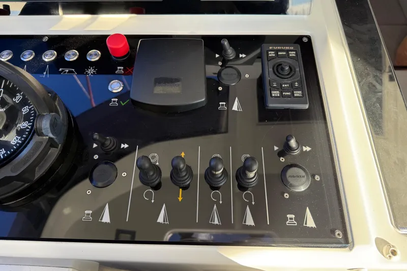 Slide: The Image of Control panel of a 2020 Amel 50 yacht with navigation instruments and switches. - 43
