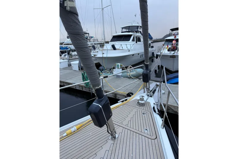 Slide: The Image of 2020 Amel 50 yacht docked at marina, showcasing deck and rigging details. - 44