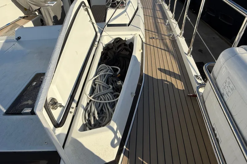 Slide: The Image of Open storage compartment on 2020 Amel 50 yacht deck with ropes inside. - 60