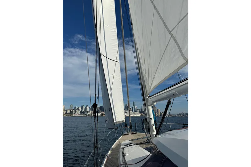 Slide: The Image of Sailing on a 2020 Amel 50 yacht with city skyline in the background. - 68