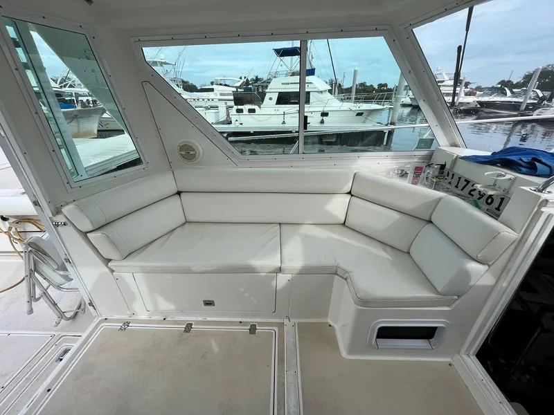 Slide: The Image of 2005 Albin 31 Tournament Express interior with white seating, docked at marina. - 13