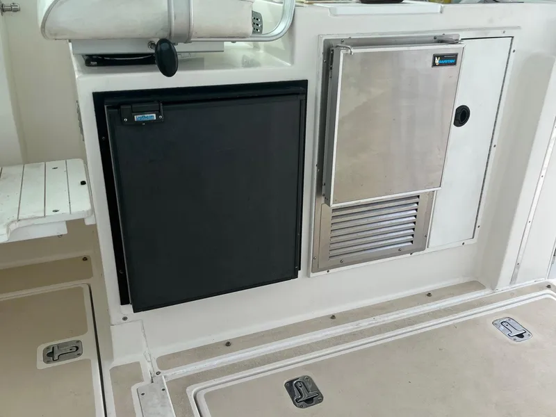 Slide: The Image of 2005 Albin 31 Tournament Express boat interior with fridge and storage compartments. - 14