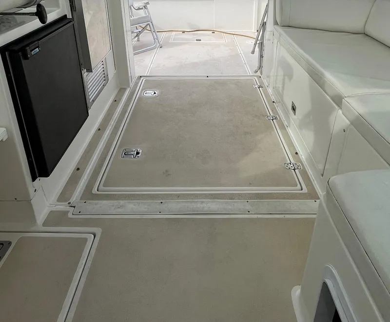 Slide: The Image of 2005 Albin 31 Tournament Express boat interior with seating and storage compartments. - 17