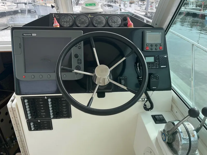 Slide: The Image of Helm of 2005 Albin 31 Tournament Express with steering wheel and navigation equipment. - 8