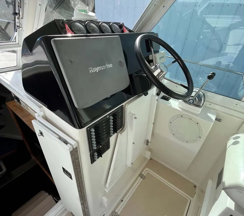 Slide: The Image of 2005 Albin 31 Tournament Express helm with Raymarine equipment and steering wheel. - 9