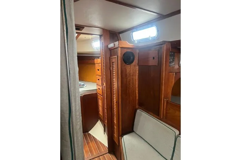 Slide: The Image of Interior of a 1977 Tartan 37 sailboat with wooden cabinetry and seating. - 14