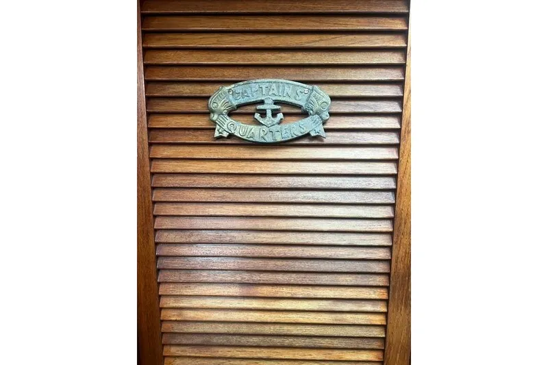 Slide: The Image of Wooden louvered door with "Captain's Quarters" sign, Tartan 37, 1977. - 15