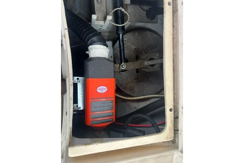 Slide: The Image of Engine compartment of a 1977 Tartan 37 sailboat with mechanical components visible. - 17