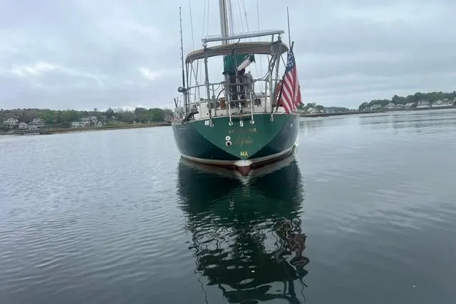 Slide: The Image of Sailboat on calm water, Tartan 37 model from 1977, with American flag. - 2