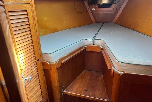 Slide: The Image of 1977 Tartan 37 sailboat cabin with wooden interior and V-berth. - 3