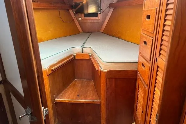 Slide: The Image of 1977 Tartan 37 sailboat cabin with wooden interior and cushioned berth. - 4