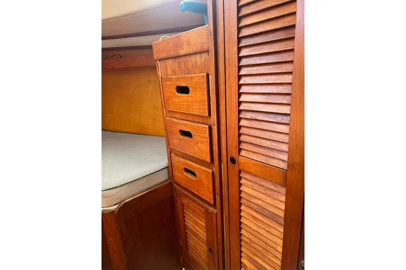 Slide: The Image of Wooden interior of 1977 Tartan 37 sailboat with drawers and louvered cabinet. - 6