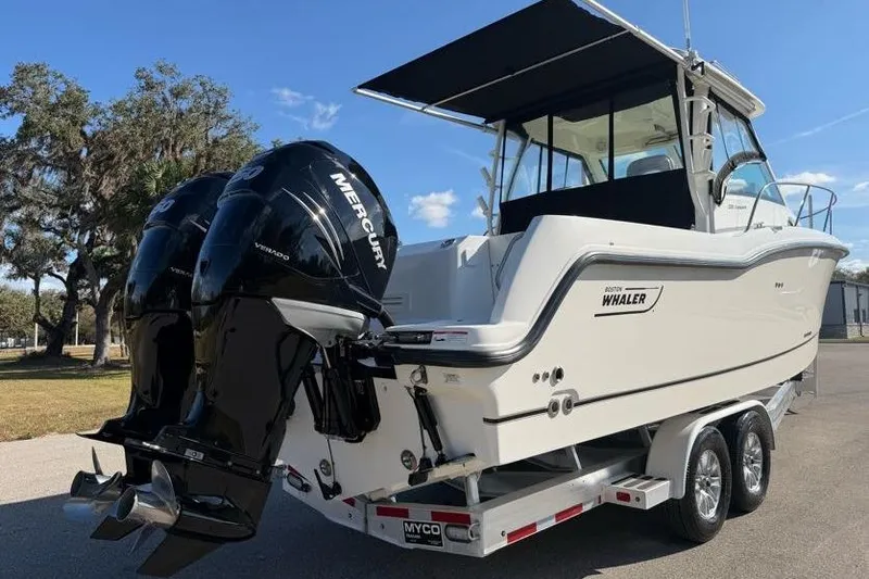 Slide: The Image of 2017 Boston Whaler 285 Conquest boat with dual Mercury engines on a trailer. - 12