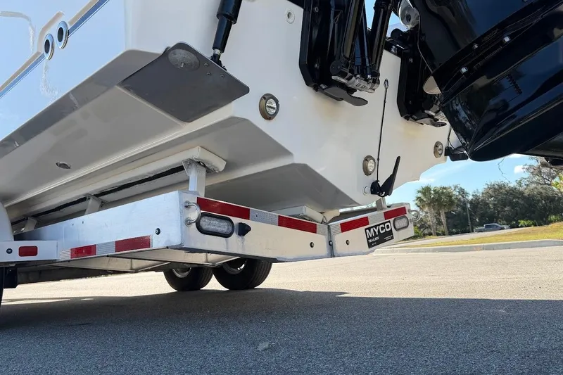 Slide: The Image of 2017 Boston Whaler 285 Conquest on Myco trailer, rear view with outboard motor. - 19