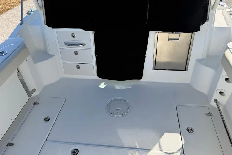 Slide: The Image of 2017 Boston Whaler 285 Conquest boat interior with storage compartments and seating. - 23
