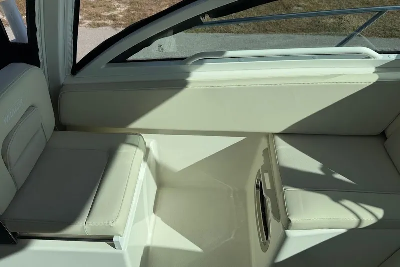 Slide: The Image of Interior seating of 2017 Boston Whaler 285 Conquest boat, featuring cream-colored upholstery. - 25