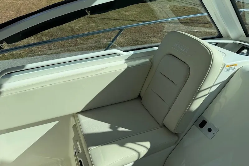 Slide: The Image of 2017 Boston Whaler 285 Conquest interior seating, featuring beige upholstery and sleek design. - 26