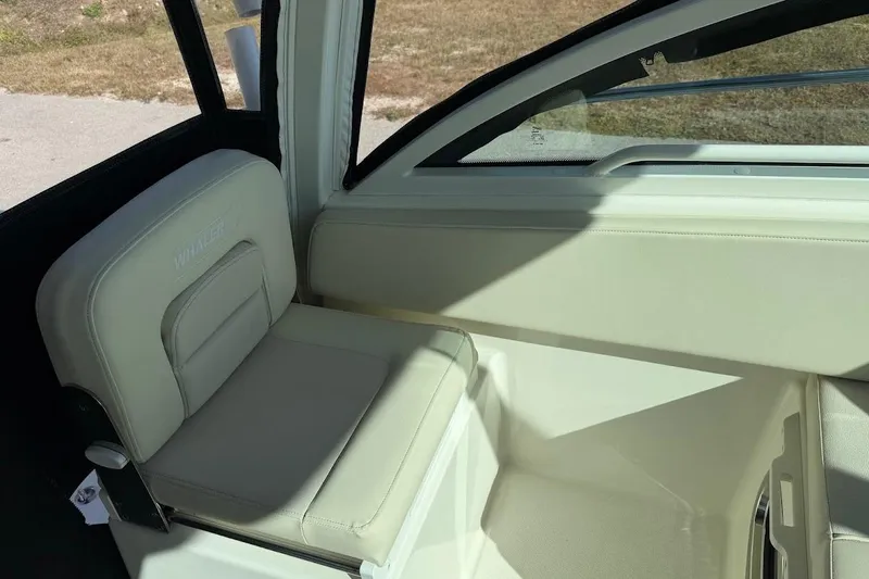 Slide: The Image of 2017 Boston Whaler 285 Conquest interior seat, featuring beige upholstery and sleek design. - 27