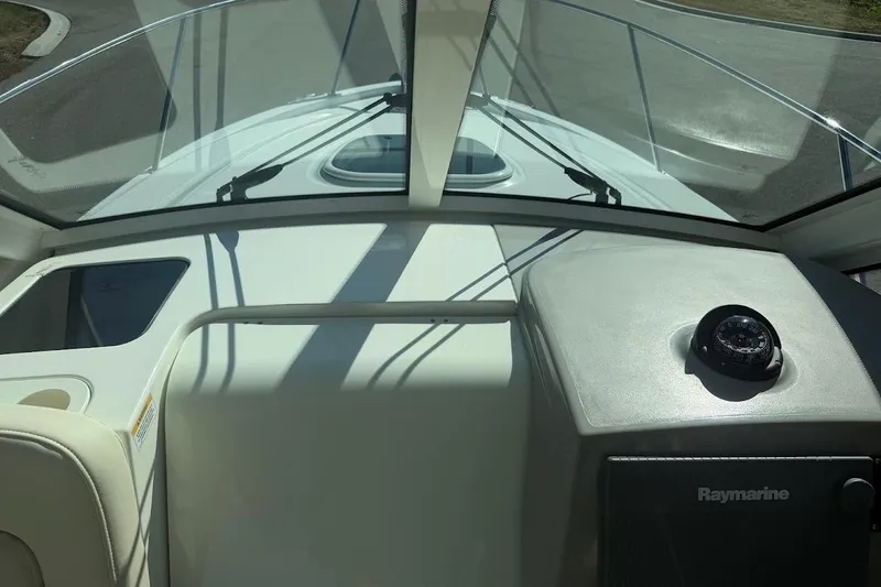 Slide: The Image of 2017 Boston Whaler 285 Conquest helm with compass and Raymarine equipment. - 30